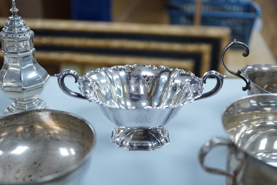 A collection of small silver wares to include a George V silver porringer, two George V silver sauce boats, a let Victorian silver sugar bowl, a George III silver goblet, with later embossed decoration, a George V small